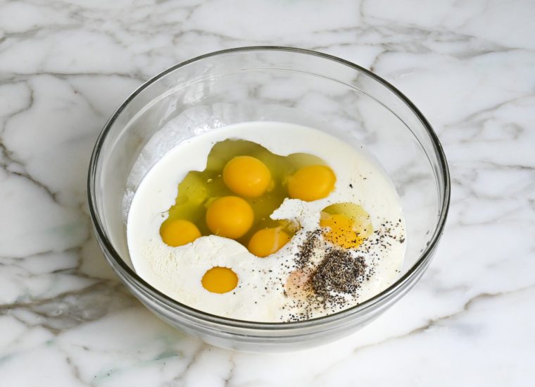 eggs, cream, and seasoning in bowl