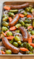 Sausage and vegetables on a sheet pan.