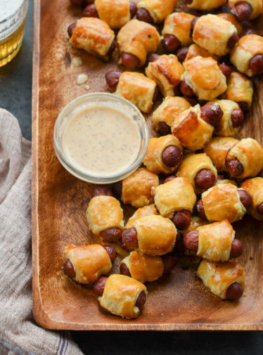 pigs in a blanket on platter with dipping sauce