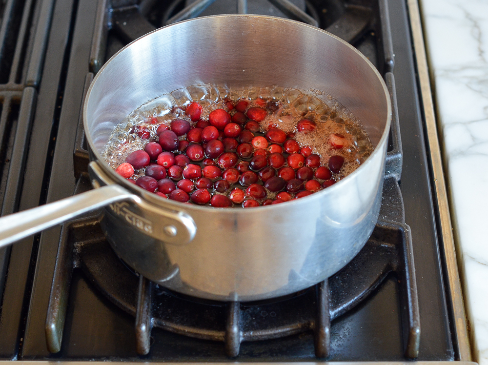 bringing cranberries and maple syrup to a boil 