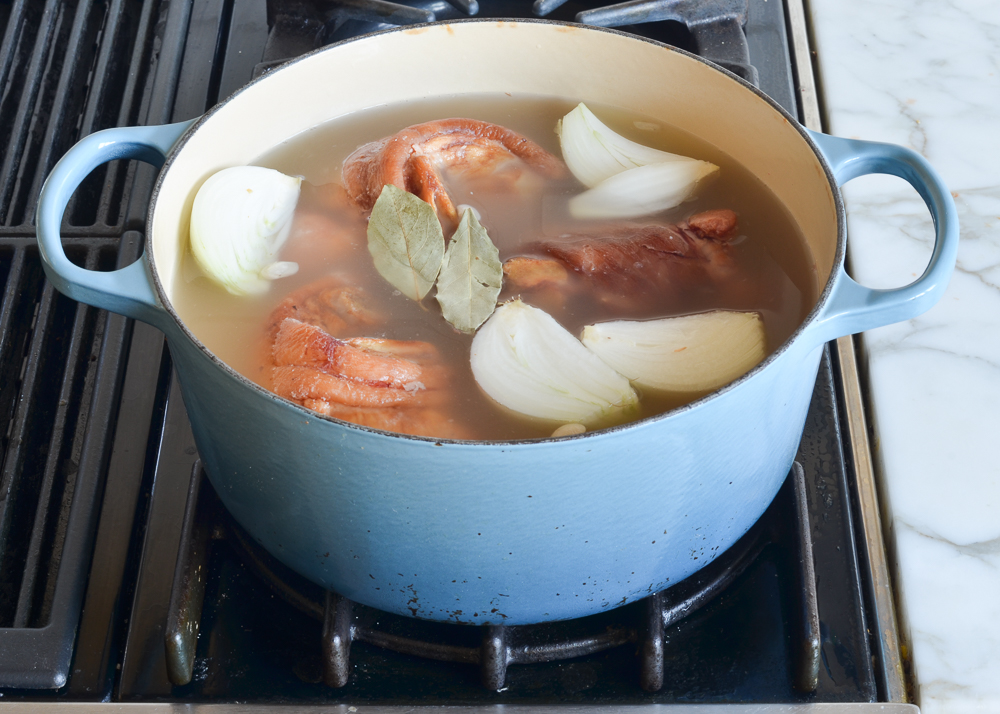 white beans, ham hocks, onion, and broth in pot