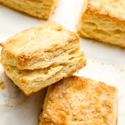 Homemade buttermilk biscuits on baking sheet.