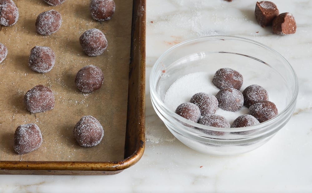 rolling dough balls in sugar