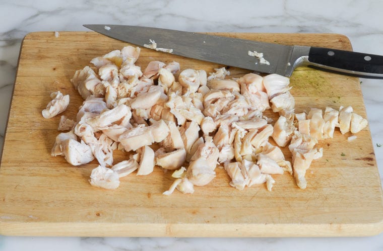 chopping the poached chicken