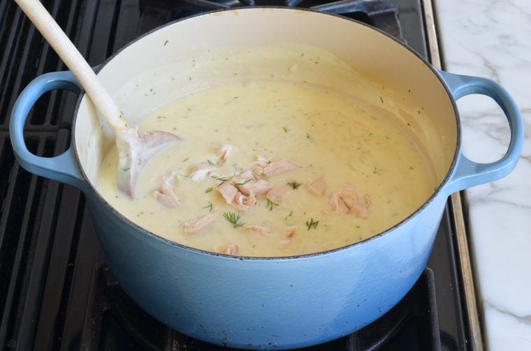 adding the poached chicken to the avgolemono soup before serving 