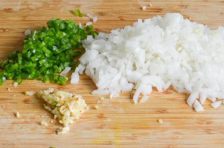 chopped onions, jalapeno peppers, garlic on cutting board