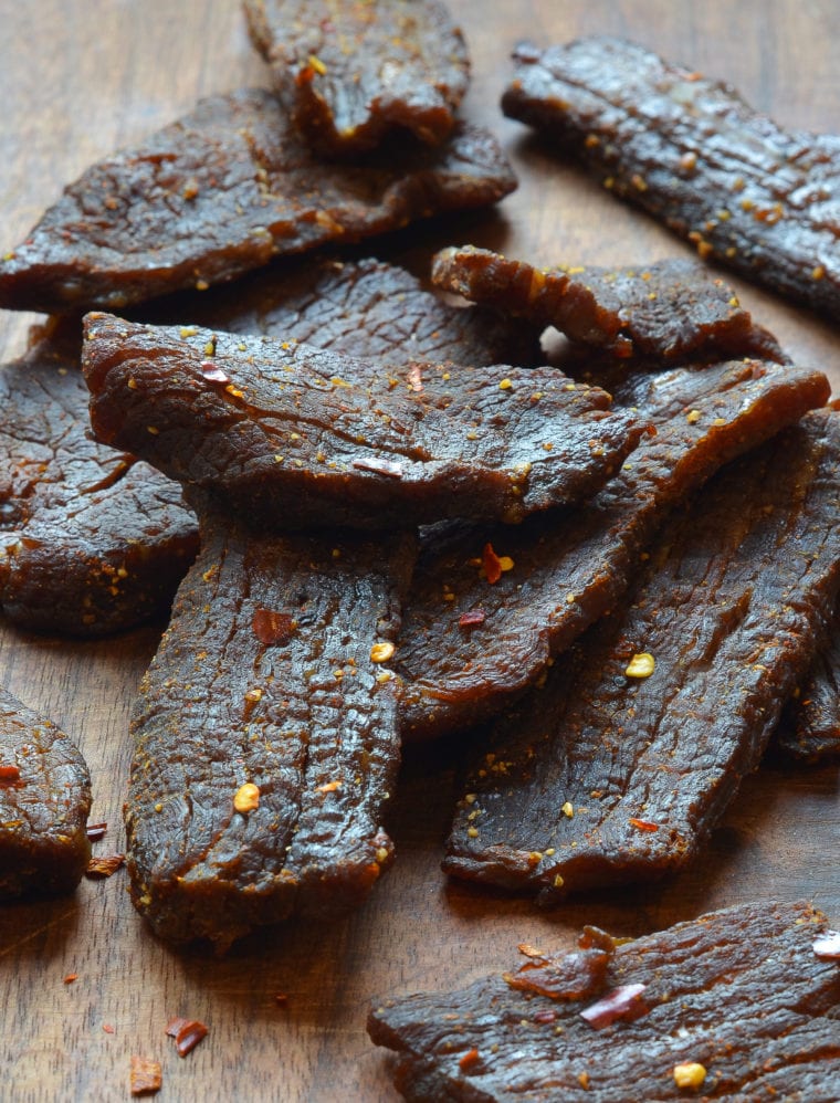 Beef jerky on a wooden surface.