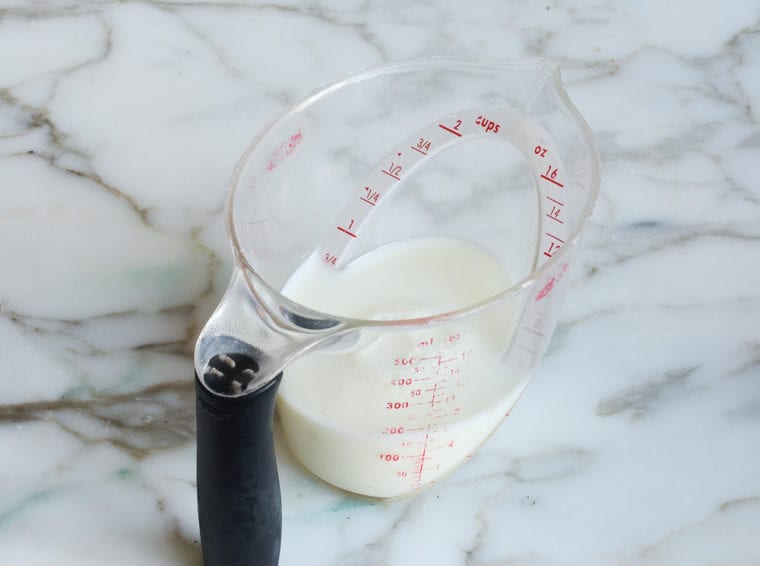 Liquid measuring cup of milk.