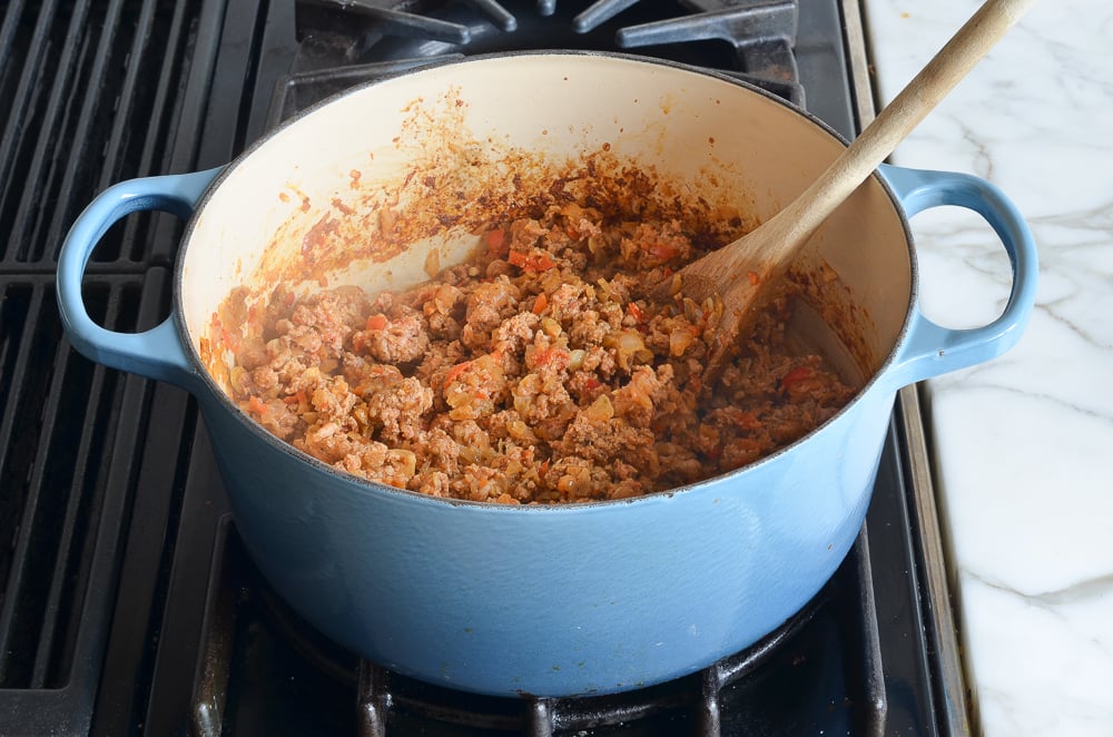 partially cooked turkey with vegetables and spices in pot