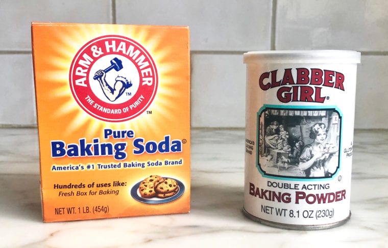 Containers of baking soda and baking powder.