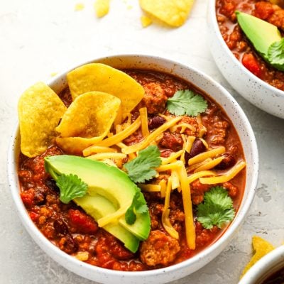 bowls of turkey chili topped with all the fixings