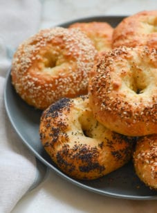 Bagels stacked on a plate.