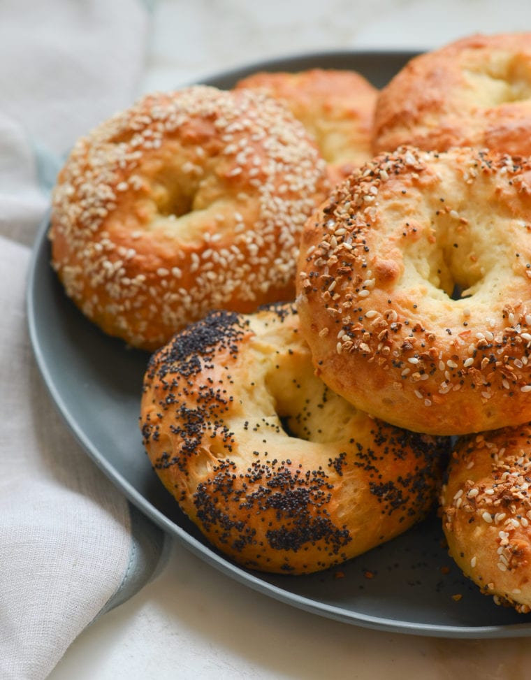 Bagels stacked on a plate.