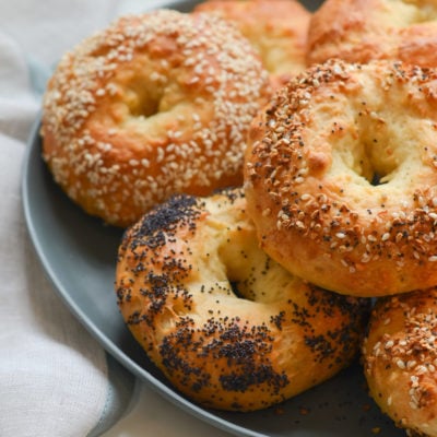 Bagels stacked on a plate.