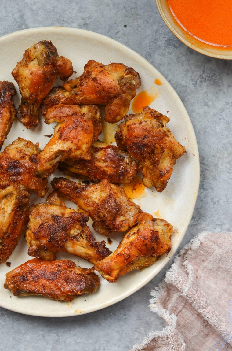 crispy baked chicken wings on plate.