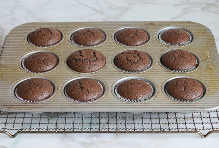 chocolate cupcakes cooling on rack