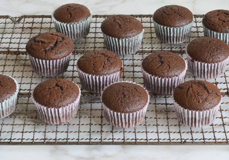 chocolate cupcakes cooling on rack
