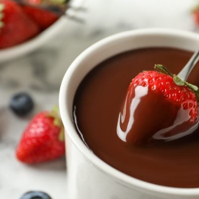 dipping strawberry into chocolate fondue