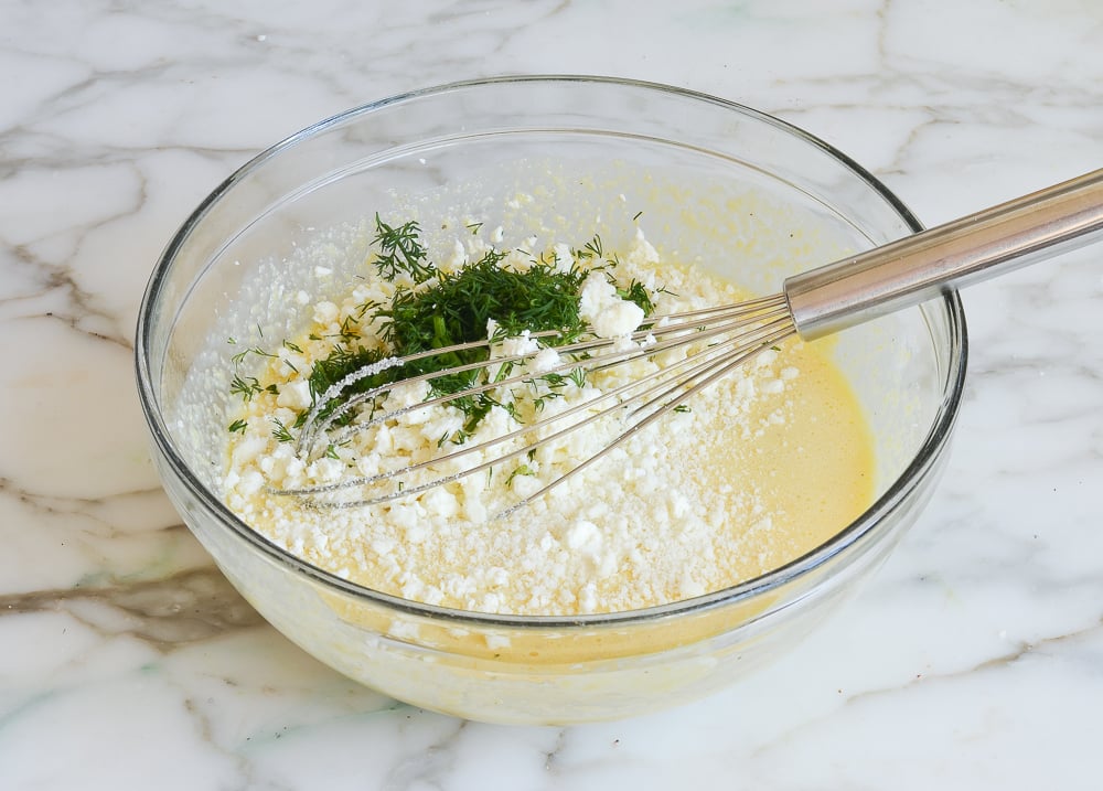 adding cheeses and herbs