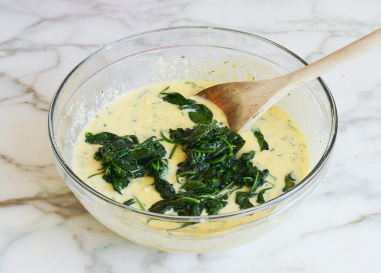 adding wilted spinach to egg batter