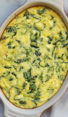 Greek-style spinach, feta, and polenta pie in a baking dish.