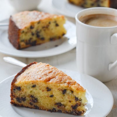 Slices of chocolate chip ricotta cake on small plates.