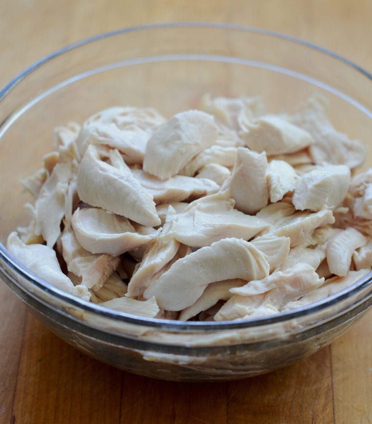 Glass bowl of poached chicken.