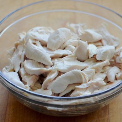 Glass bowl of poached chicken.