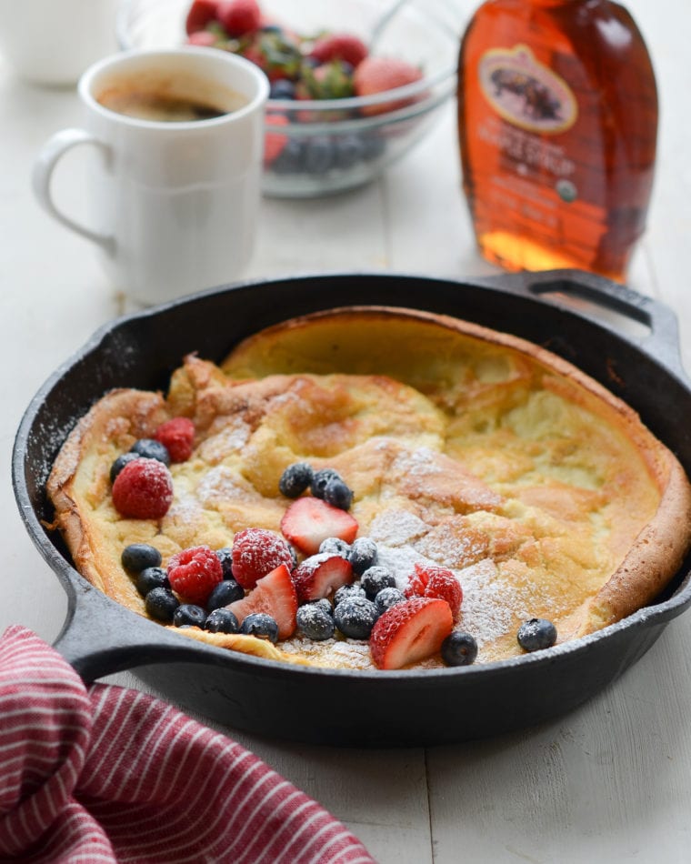 Dutch baby in a skillet with fruit.