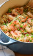 Orzo risotto with shrimp, peas, and bacon in a Dutch oven.