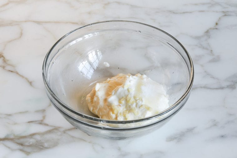 mayonnaise, sour cream, lime, garlic and seasoning in bowl