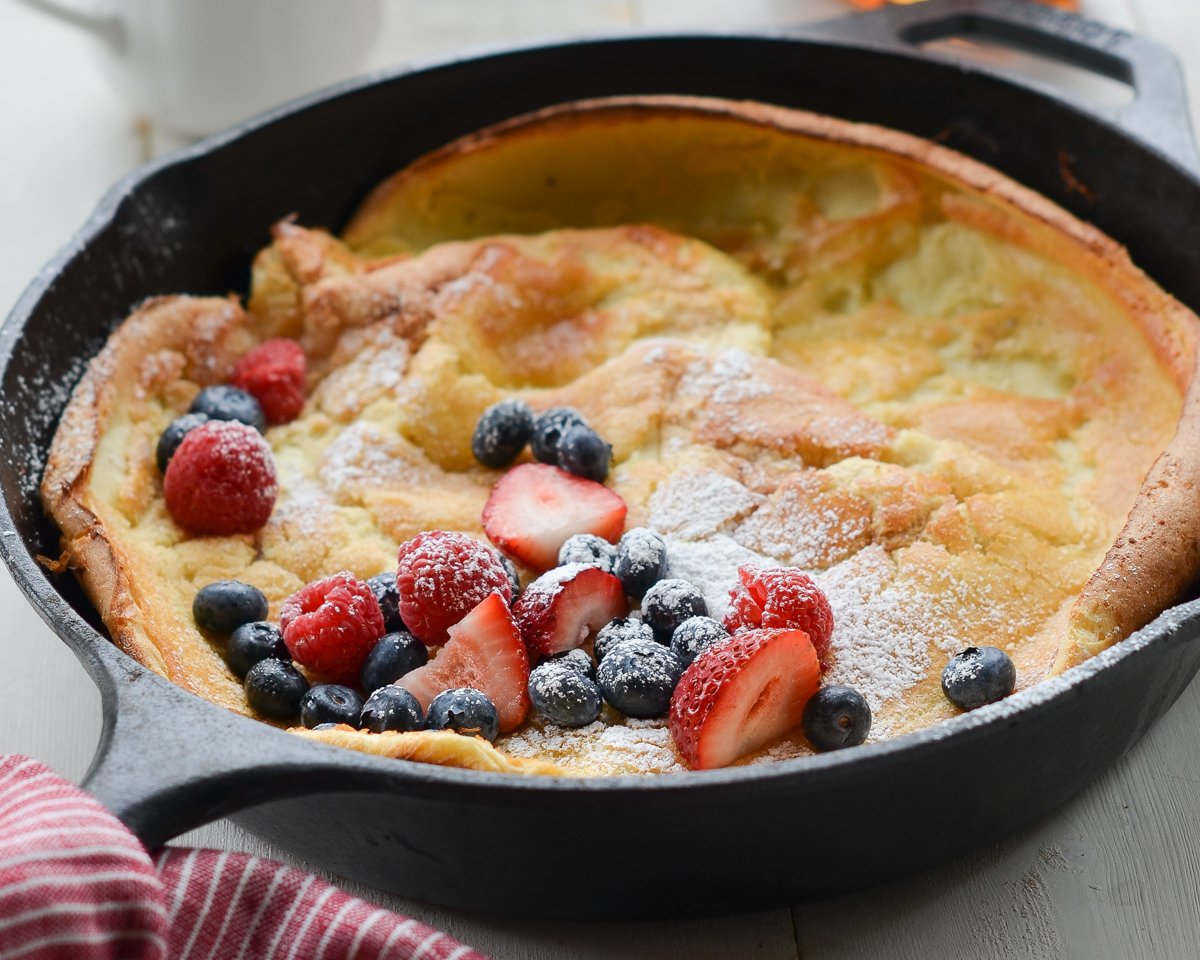Dutch baby in skillet with berries