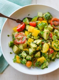 Spoon in a bowl with a summer avocado salad.