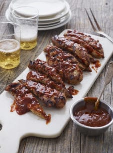 Grilled barbeque chicken on a cutting board.