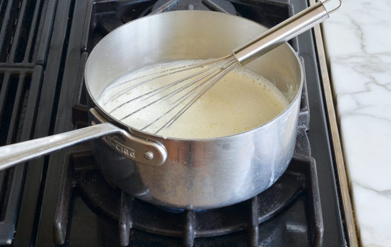 whisking pastry cream in saucepan
