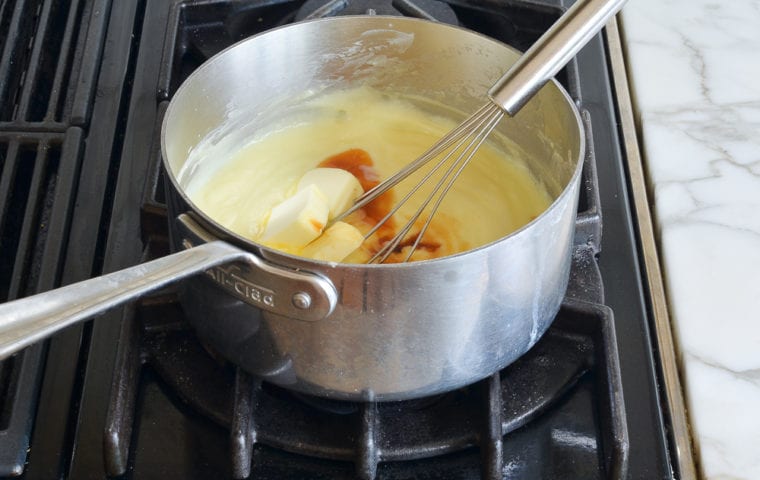 stirring butter and vanilla into thickening pastry cream