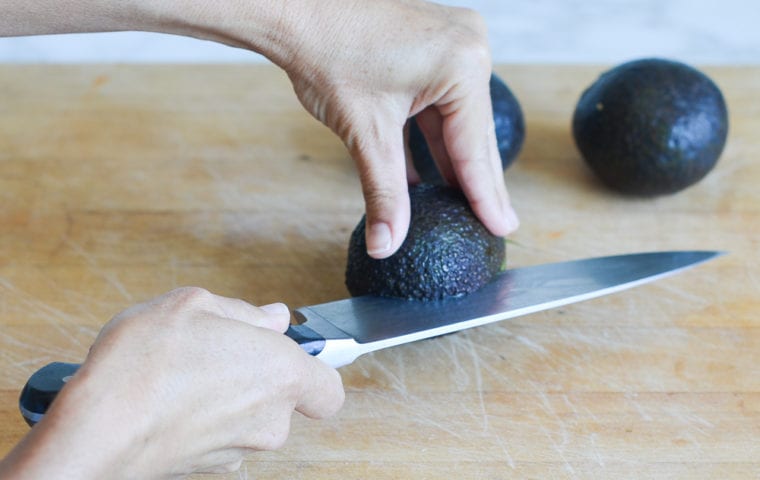 cutting around the pit of the avocado
