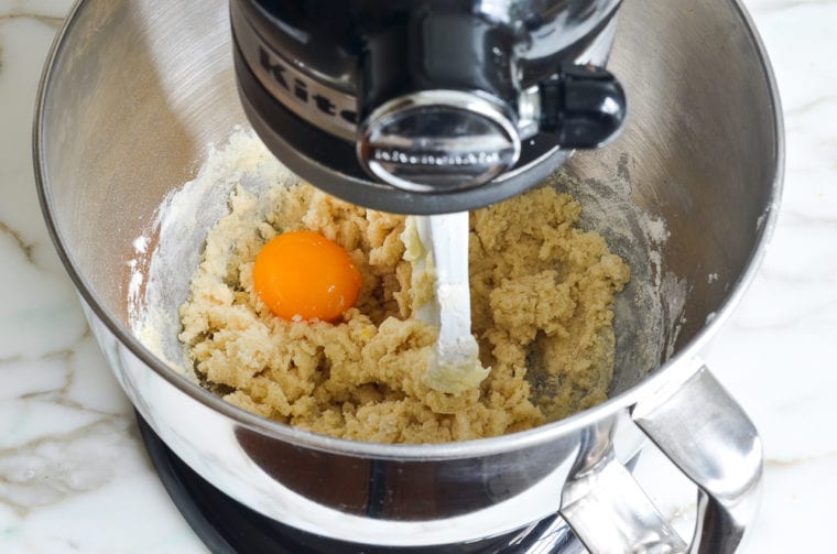 adding egg yolk to pate sucree dough