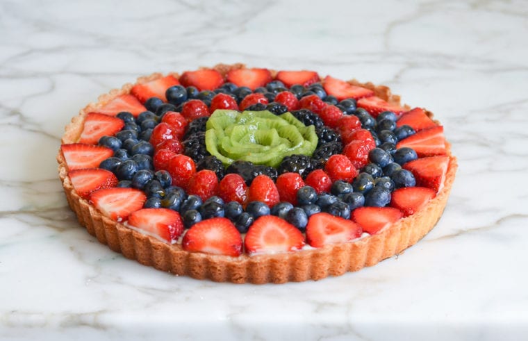 concentric circles of fruit with kiwi rose in center