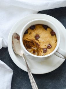 Chocolate chip cookie in a mug, missing a scoop.
