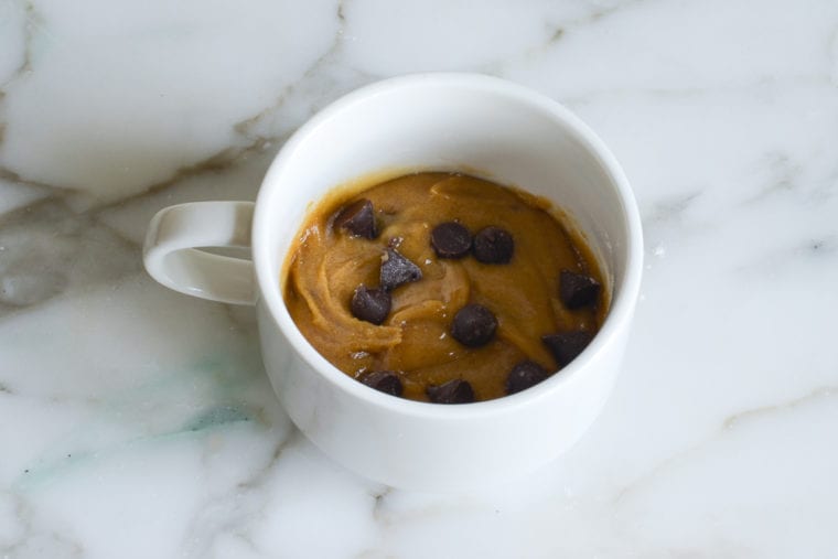 cookie in a mug batter with chocolate chips