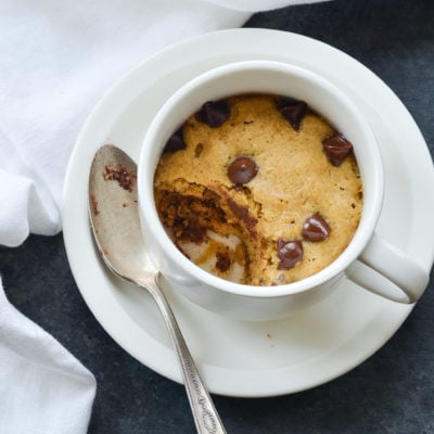 Chocolate chip cookie in a mug, missing a scoop.