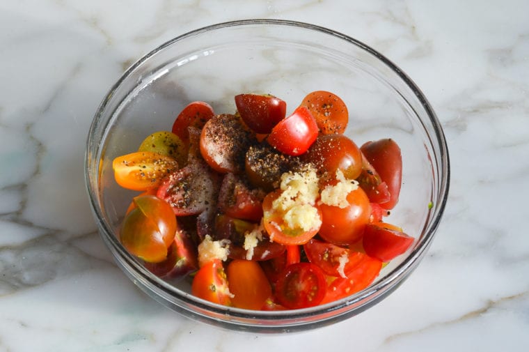 cherry tomatoes and seasoning in bowl