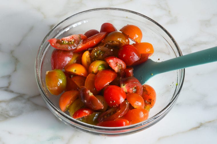 tossed cherry tomatoes and seasoning