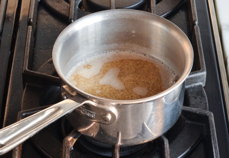 adding bulgur to boiling water