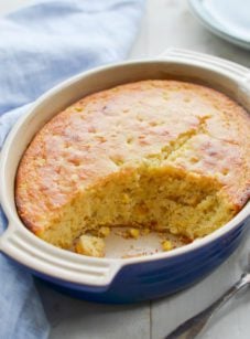 Partially-served dish of spoon bread.