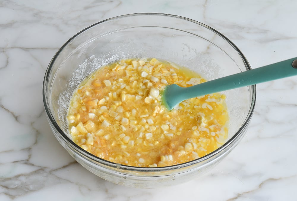 creamed corn, corn, and melted butter in bowl