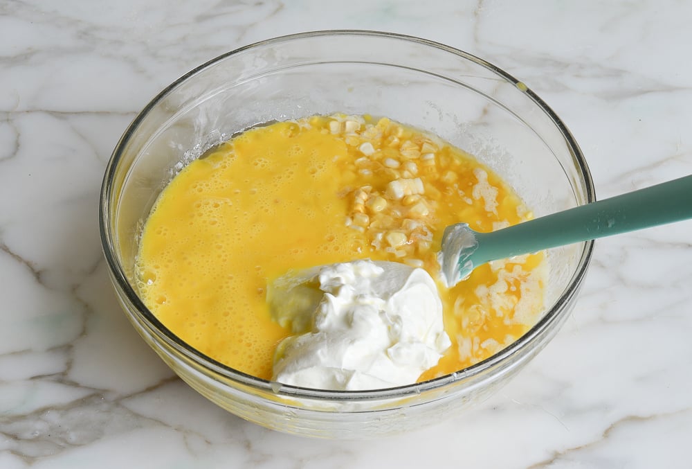 adding sour cream and beaten eggs