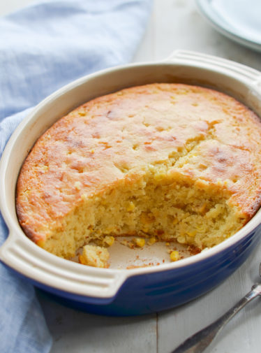 Partially-served dish of spoon bread.