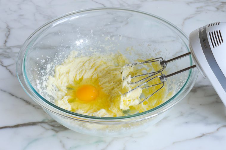 adding eggs to batter one at a time